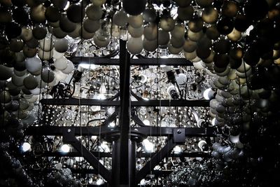 Close-up of illuminated chandelier seen through glass window