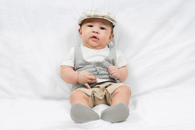 Portrait of adorable little baby boy on white wall background. innocence and babyhood.