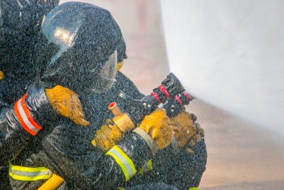 Firefighters spraying water with hose