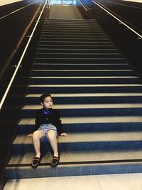  view of young boy sitting on stairs