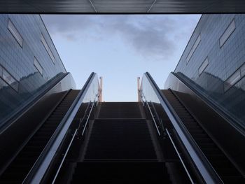 Low angle view of escalator against sky