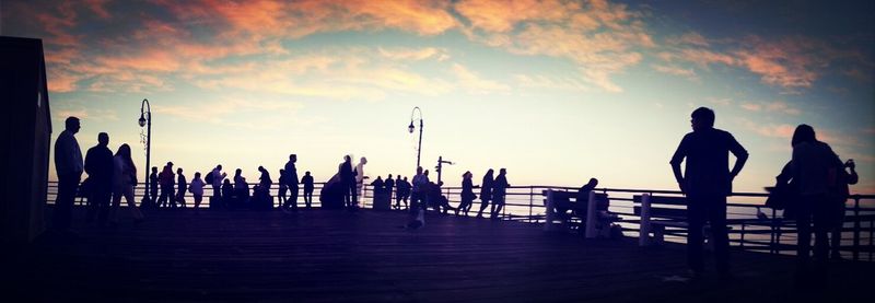 Silhouette of people on beach at sunset