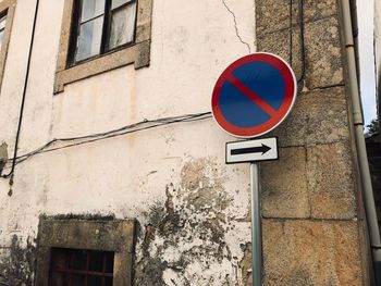 Low angle view of road sign on building