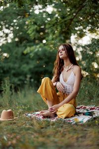 Young woman sitting on field