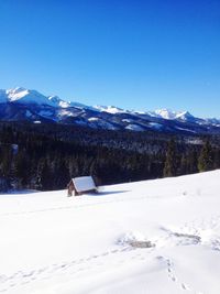 Houses on snow covered landscape against sky