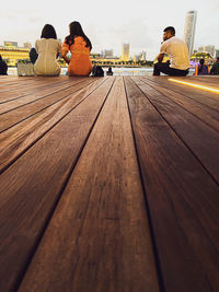 People sitting on bench in city