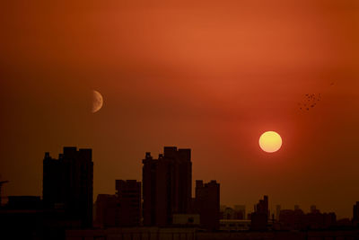 Scenic view of buildings against sky during sunset