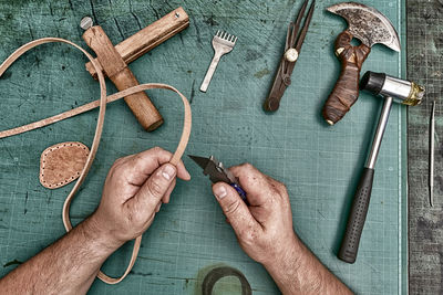 Cropped hands of man working at workshop