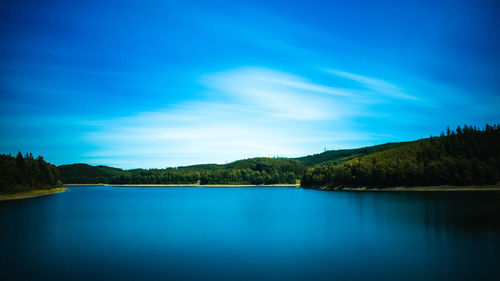 Scenic view of lake against blue sky