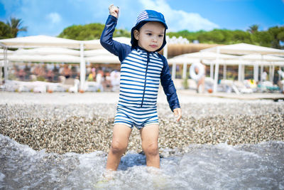 Portrait of boy standing on rock