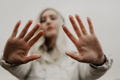 Cropped hand gesturing against white background