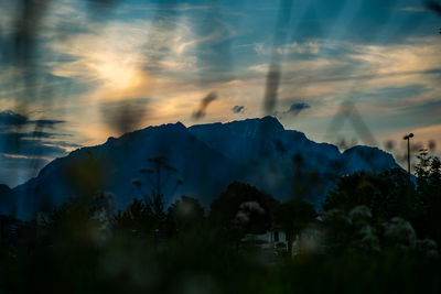 Scenic view of mountains against sky at sunset