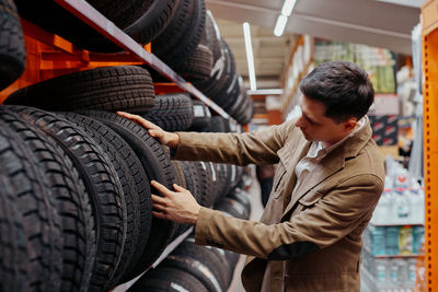 Man choosing tire at store