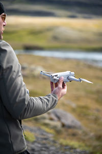 Man takes off the drone from the hand