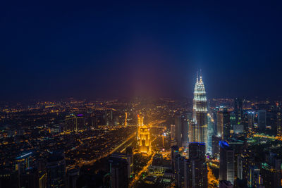 High angle view of city lit up at night