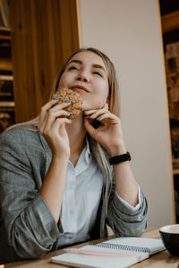 Smiling girl drinking coffee at cafe