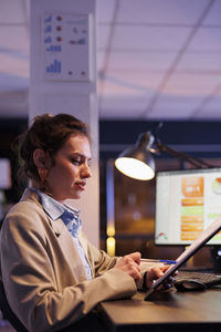 Portrait of businessman using mobile phone in office