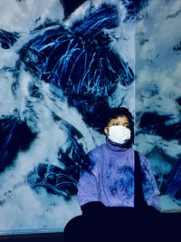 High angle view of woman sitting in snow