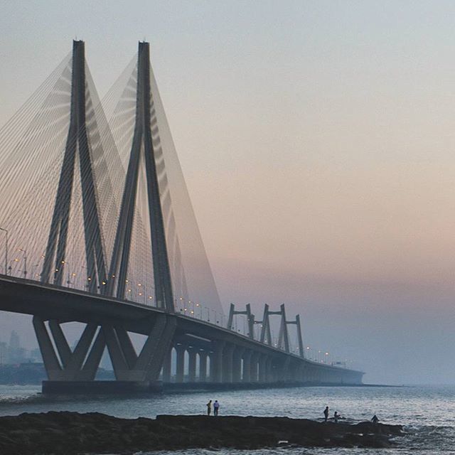 sea, water, built structure, architecture, horizon over water, sky, sunset, silhouette, suspension bridge, engineering, scenics, beach, connection, tranquility, waterfront, bridge - man made structure, tranquil scene, nature, travel destinations, beauty in nature