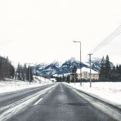 Road passing through snow covered landscape