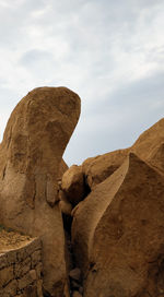 Low angle view of rock formation against sky