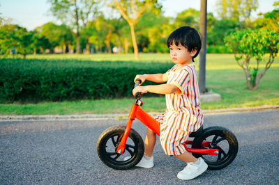 Side view of boy with bicycle