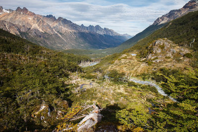 Scenic view of valley and mountains against sky