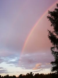 Low angle view of rainbow against sky at sunset