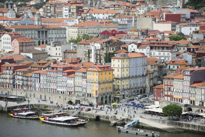 Boats in river with buildings in background