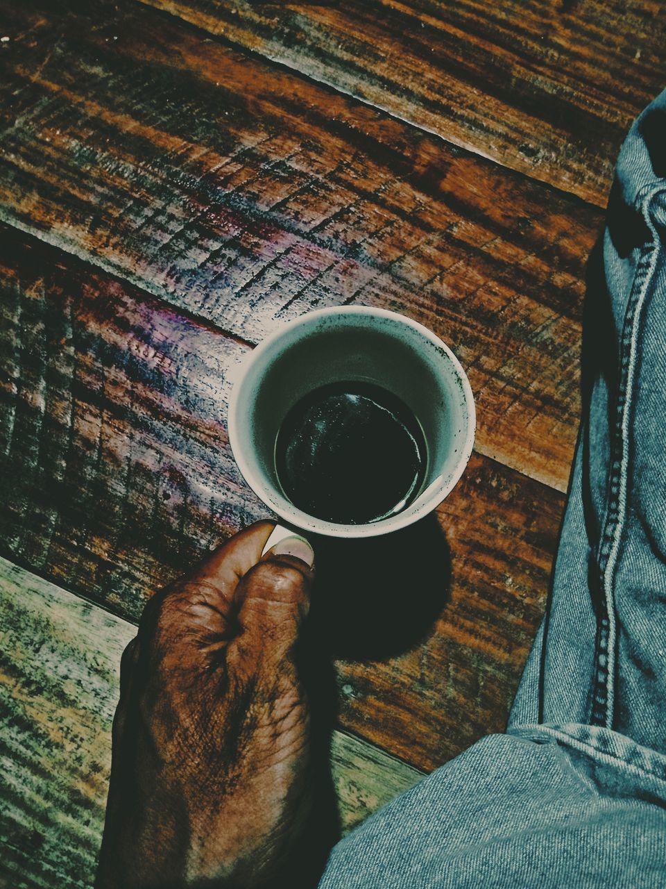 drink, cup, refreshment, domestic animals, coffee, domestic, mammal, animal themes, coffee - drink, pets, real people, animal, one animal, low section, food and drink, human leg, one person, coffee cup, mug, indoors, pet owner, wood, human foot