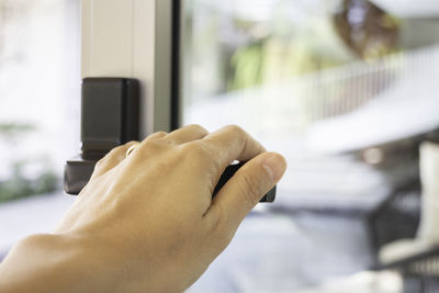 Close-up of man holding hands on table