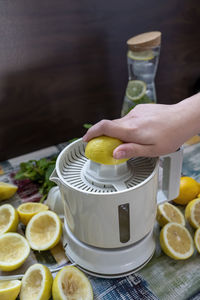 Preparation of fresh juices press on fresh lemon and lime. lemon squeezer machine or lemon presser.