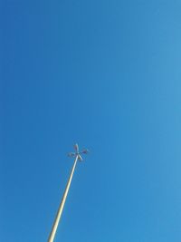 Low angle view of street light against clear blue sky