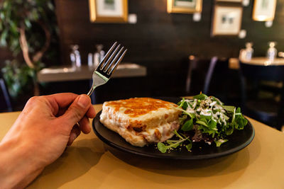 Midsection of person having food on table