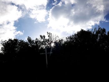 Low angle view of silhouette trees against sky