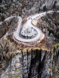 High angle view of vehicles on road along trees