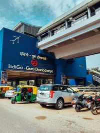 Vehicles on road against buildings in city