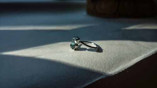 Close-up of wedding ring on table