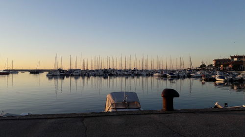 Sailboats in marina at sunset