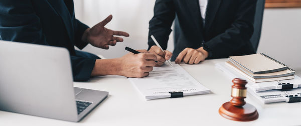 Midsection of business colleagues working in office