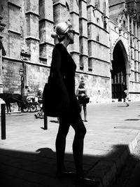 Low angle view of woman standing by railing