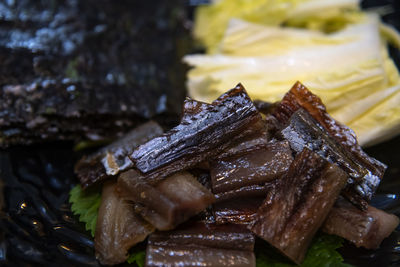 Close-up of food  of  half-dried herring slices, napa cabbage and dried seaweed in plate