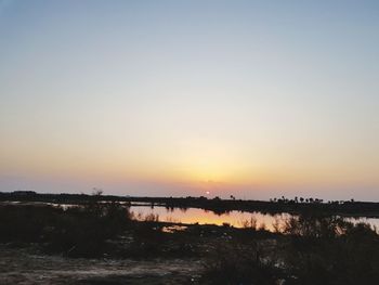 Scenic view of silhouette landscape against clear sky during sunset