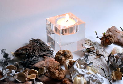 High angle view of lit candles on table