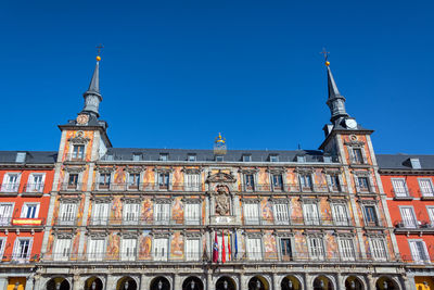 Low angle view of plaza mayor against clear blue sky