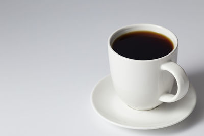 Close-up of coffee cup on white background