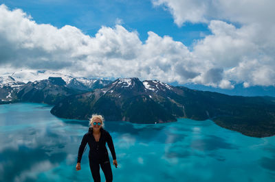 Full length of woman standing in sea during winter