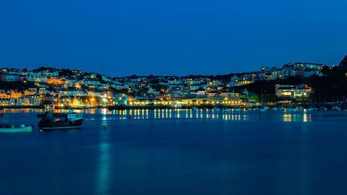 Illuminated buildings against sky at night