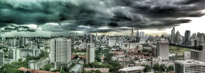 City skyline against cloudy sky