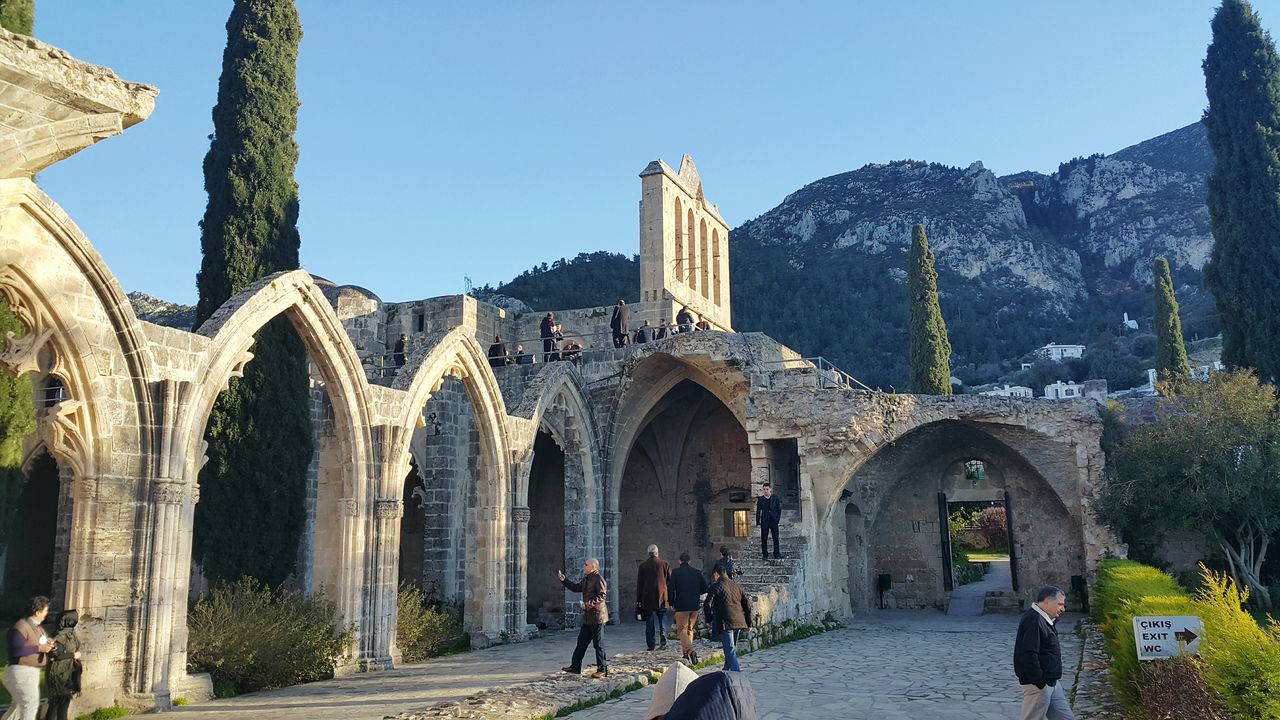 architecture, built structure, arch, building exterior, men, lifestyles, person, clear sky, history, tourist, tourism, leisure activity, walking, travel, famous place, religion, travel destinations, place of worship, the past